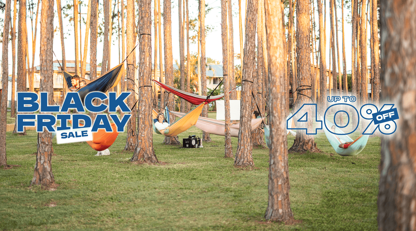 A family all relaxing in different hammocks together 