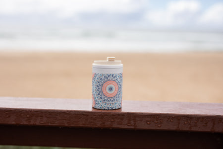 Sound of Summer Cooler & Coffee Cup on a railing at the beach