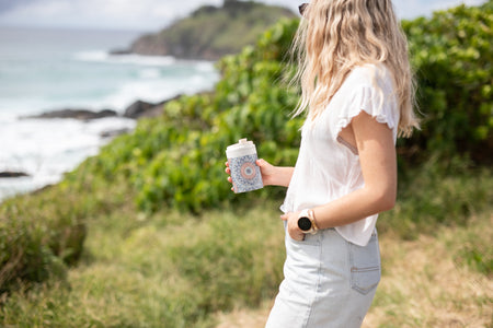 Sound of Summer Cooler & Coffee Cup held on a coastal clifftop