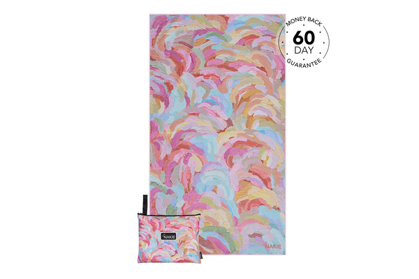 Colorful abstract brushstroke beach towel in pink, blue, yellow, and coral with matching compact carry pouch.