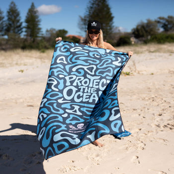 Blue and white abstract patterned recycled beach towel with 