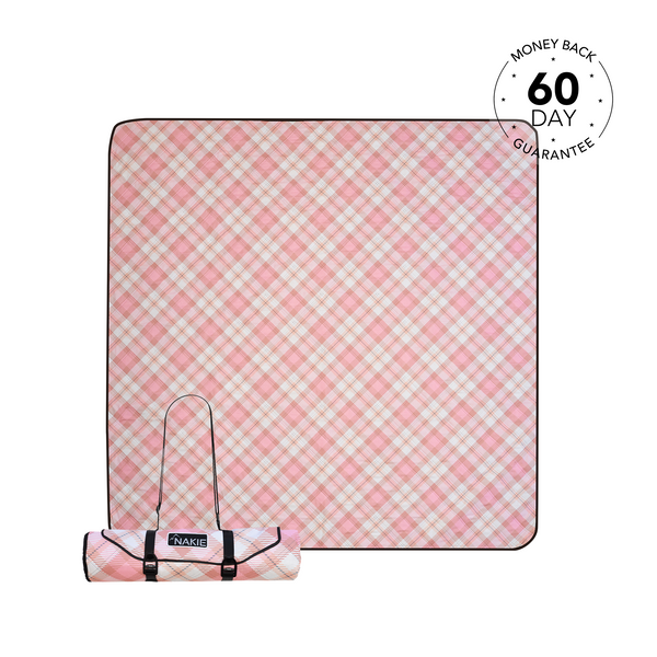 Pink and white gingham picnic blanket rolled and unrolled view with carrying straps and NAKIE branding