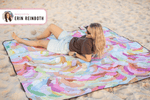 Colorful abstract painted recycled picnic blanket with multicolor brushstrokes, displayed on beach sand. preview #2
