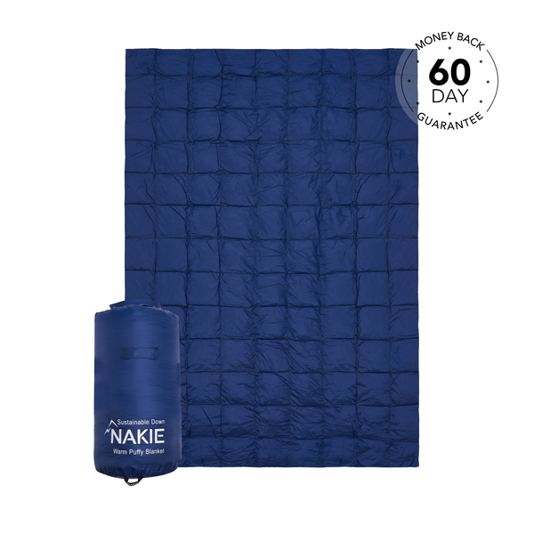 Studio shot of Nakie's Deep Ocean Blue puffy blanket, showcasing its cozy warmth and eco-friendly design