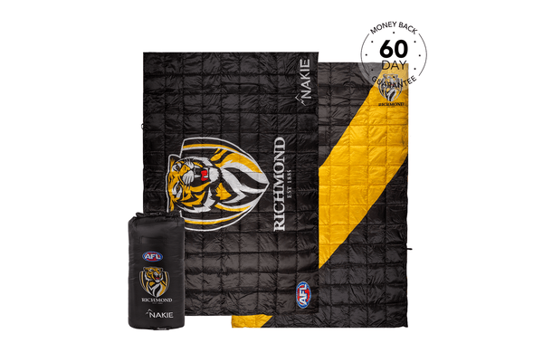 Black quilted puffy blanket with Richmond Tigers logo, yellow lining, and Nakie branding, shown unfolded and partially rolled