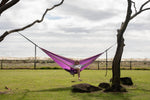 Purple Nakie hammock in a studio, emphasizing its recycled plastic bottle construction and portable design preview #8