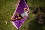 Woman lounging in a purple Nakie hammock, viewed from above, highlighting its eco-friendly and comfortable design preview #7