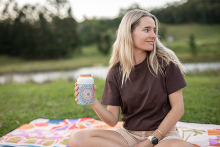 Woman with a Sound of Summer Cooler & Coffee Cup on a picnic blanket